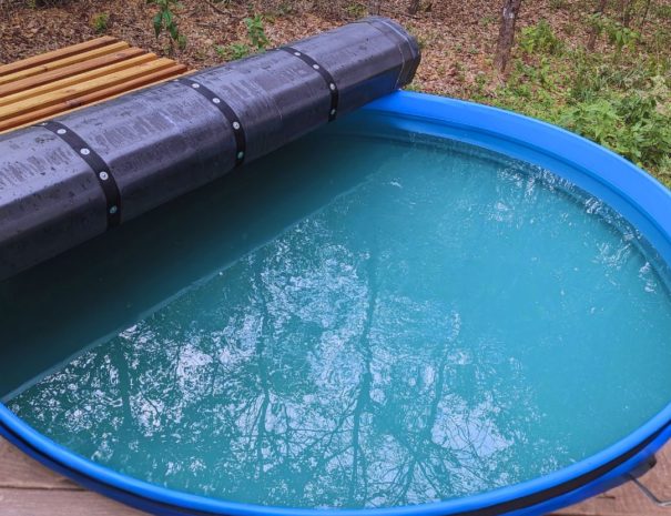 Relax in comfort with our stock tank pool, featuring a convenient cover for added safety and comfort